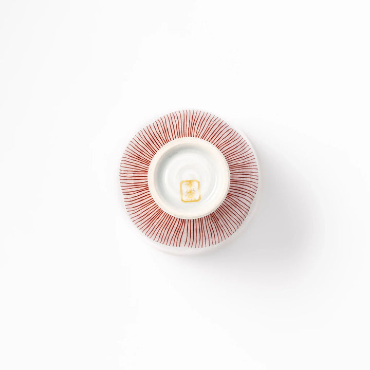 Japanese ceramic tea cup with plum petal stripe design in red, combining traditional elegance and modern simplicity