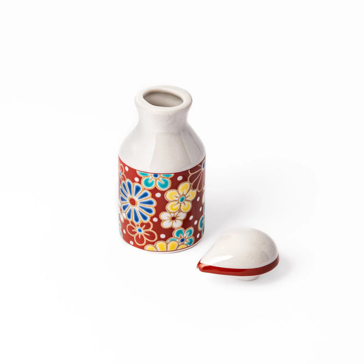 Japanese ceramic soy sauce dispenser with red lid and plum and chrysanthemum blossoms handcrafted in Arita.