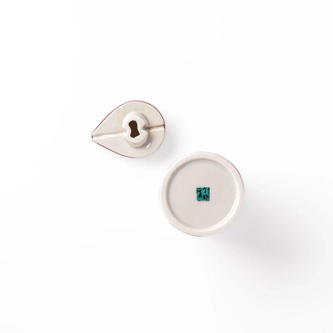 Japanese porcelain soy sauce dispenser with red floral pattern featuring plum and chrysanthemum blossoms, handcrafted design.