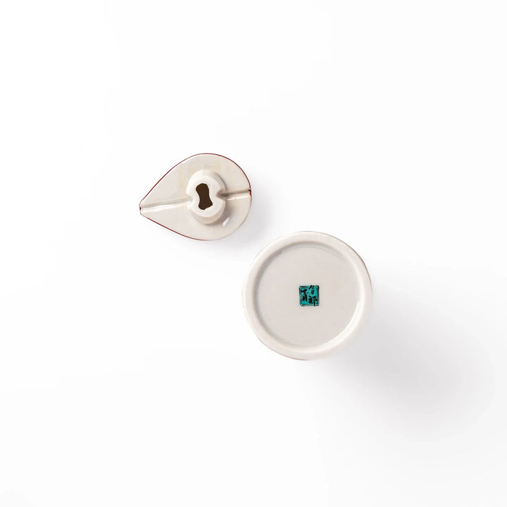 Japanese porcelain soy sauce dispenser with red floral pattern featuring plum and chrysanthemum blossoms, handcrafted design.