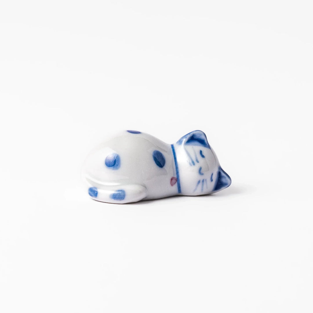 Blue polka dot cat-shaped ceramic chopstick rest with a relaxed expression, bringing a whimsical charm to your dining table.