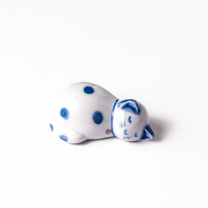 Blue polka dot cat-shaped ceramic chopstick rest with a relaxed expression, bringing a whimsical charm to your dining table.