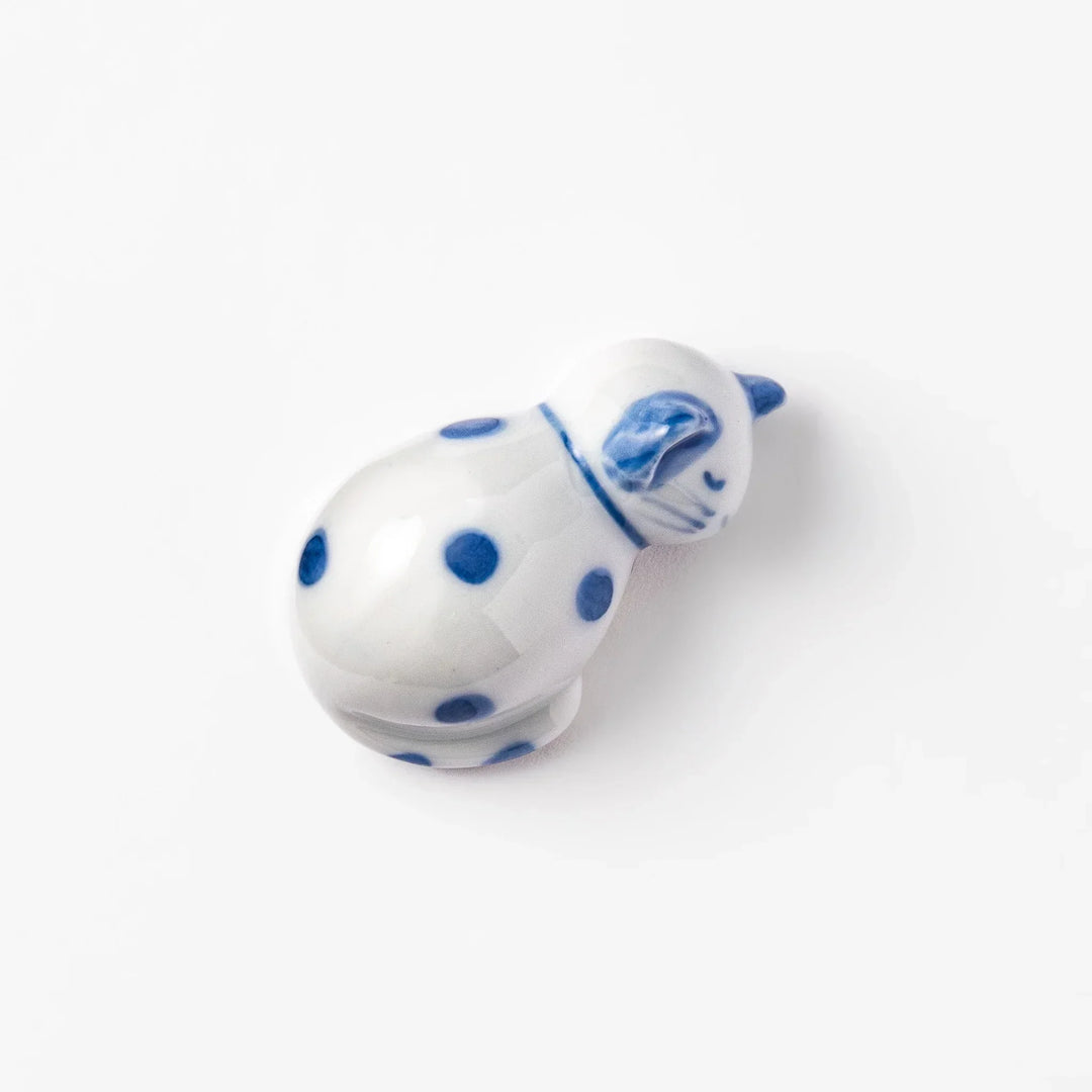 Blue polka dot cat-shaped ceramic chopstick rest with a relaxed expression, bringing a whimsical charm to your dining table.