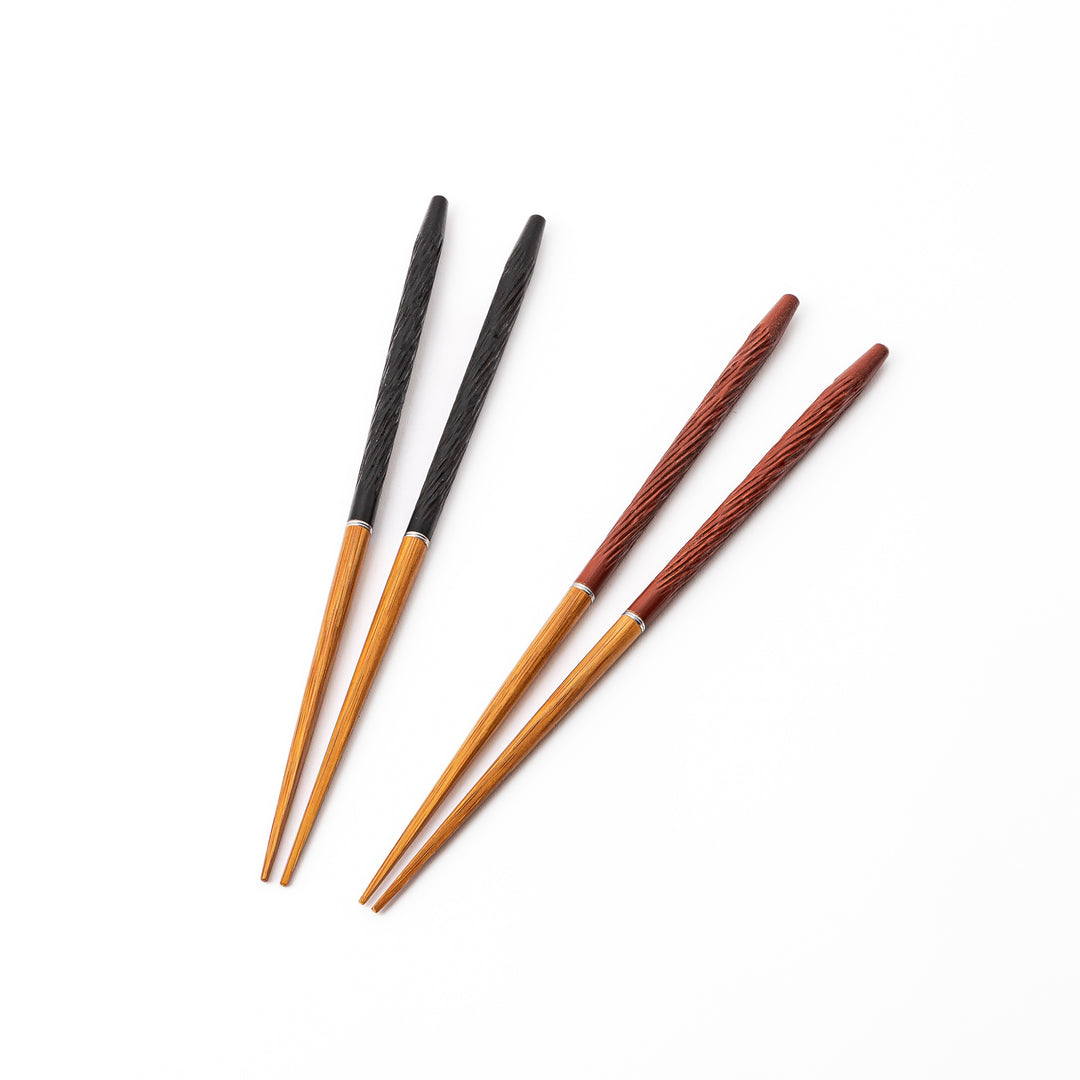 Two pairs of portable Japanese travel chopsticks in black and red showing the detailed textured handles and natural wood tips