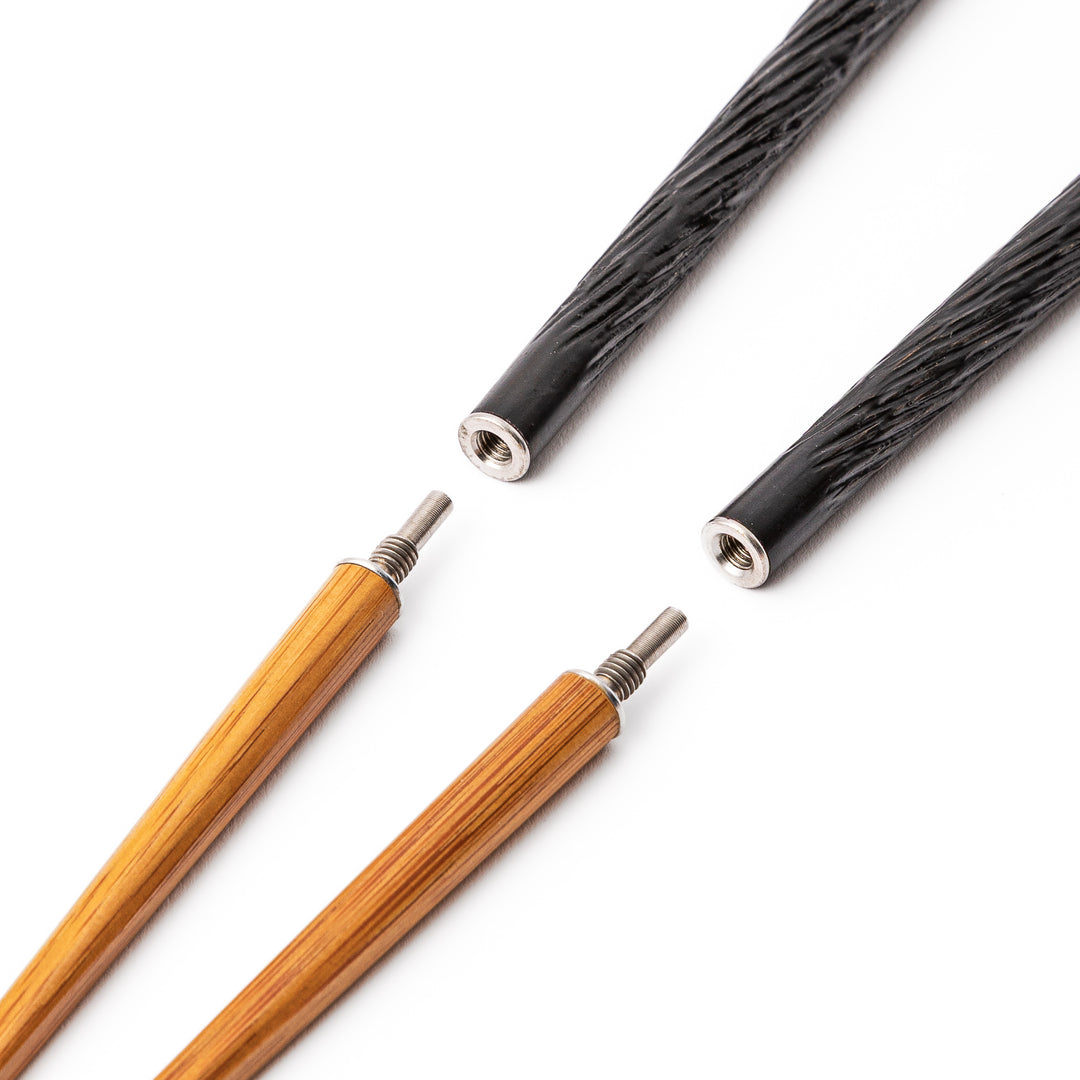 Black Japanese travel chopsticks unscrewed into two parts to demonstrate the portable design and durable metal joints