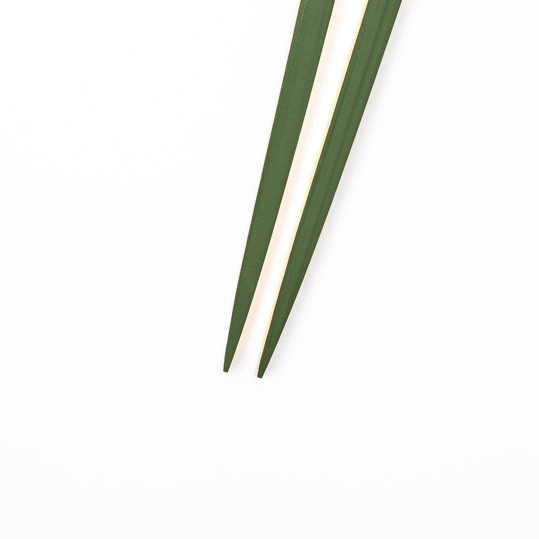 A pair of precision Japanese bamboo cooking chopsticks featuring slim green handles and ultra fine tapered tips for delicate plating