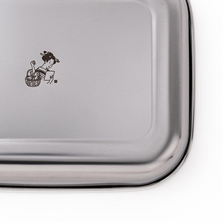 Stainless steel prep tray with engraved woman illustration blending Japanese design and kitchen function.