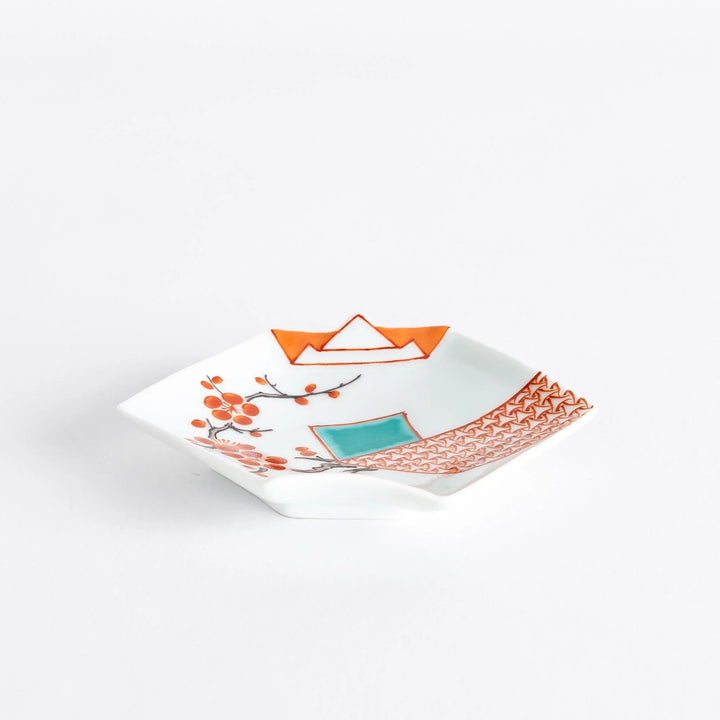 Square Japanese porcelain sauce dish with red plum blossoms turquoise square and orange geometric pattern.