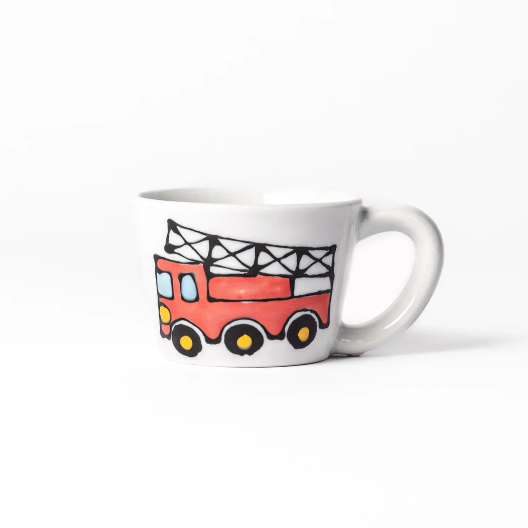 White ceramic kids mug featuring red fire truck with ladder graphic, round handle, shown on white background