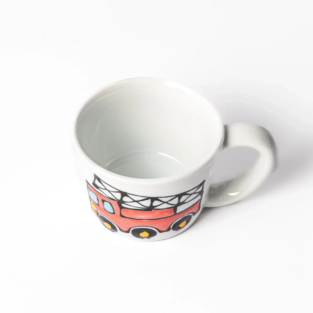 White ceramic kids mug featuring red fire truck with ladder graphic, round handle, shown on white background