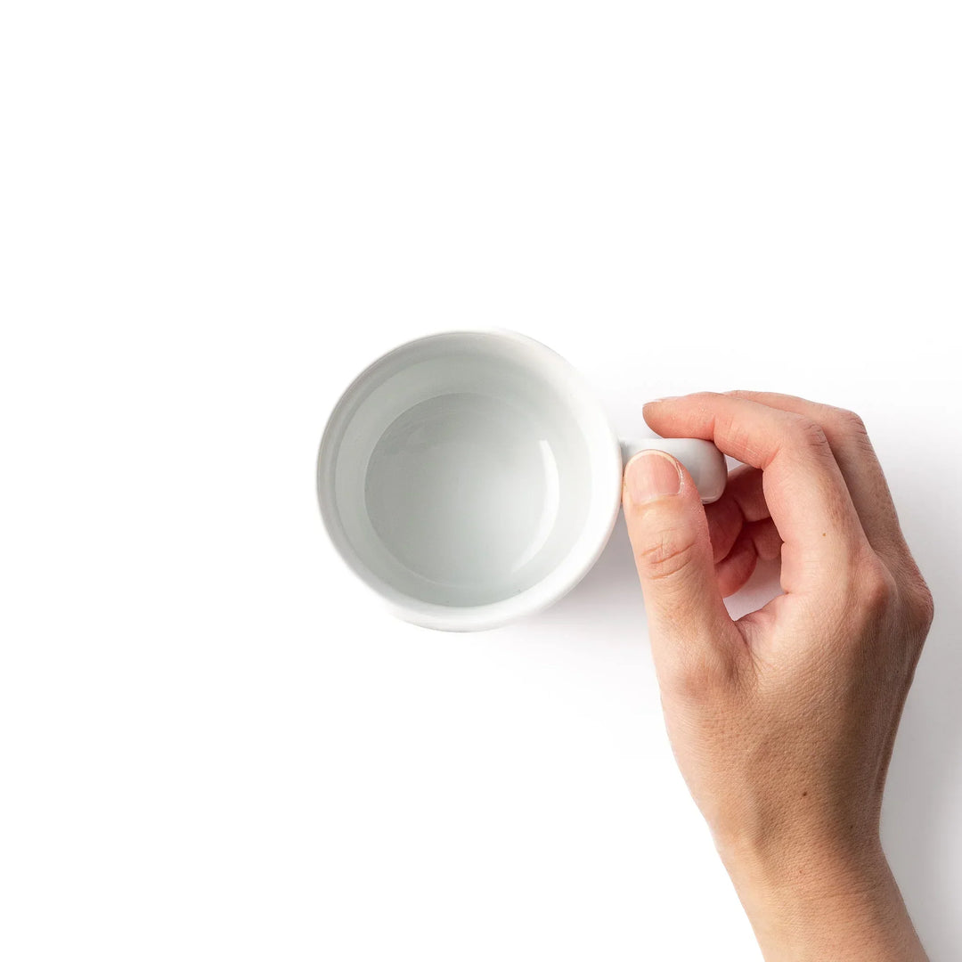 White ceramic kids mug featuring red fire truck with ladder graphic, round handle, shown on white background