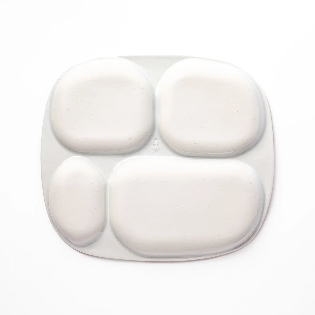 White ceramic kids plate with police car, airplane, fire truck, and rocket motifs in divided sections