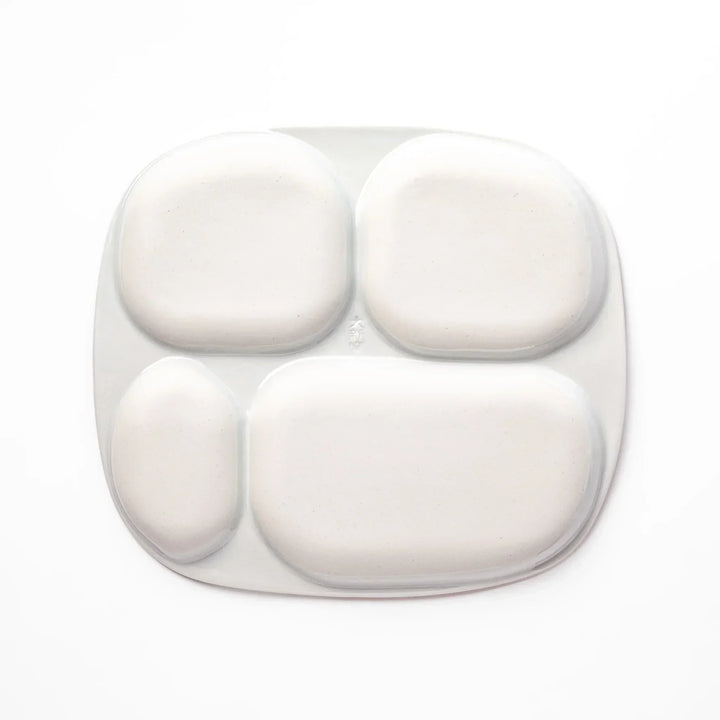 White ceramic kids plate with police car, airplane, fire truck, and rocket motifs in divided sections