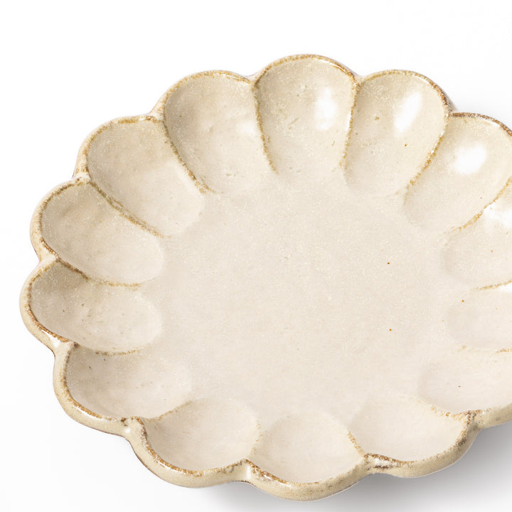 Medium Japanese Rinka ceramic petal salad plate in off white, seen from above, featuring a flower shaped rim