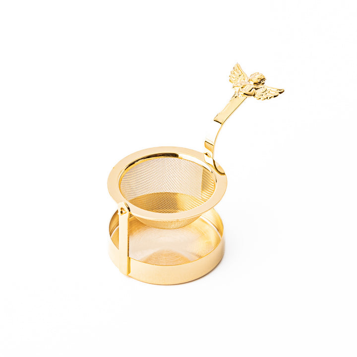 Elegant Japanese rotating gold angel tea strainer with stainless steel mesh basket and drip catcher base