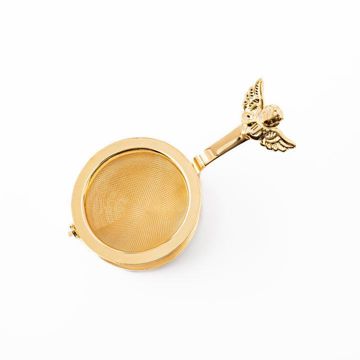 Elegant Japanese rotating gold angel tea strainer with stainless steel mesh basket and drip catcher base