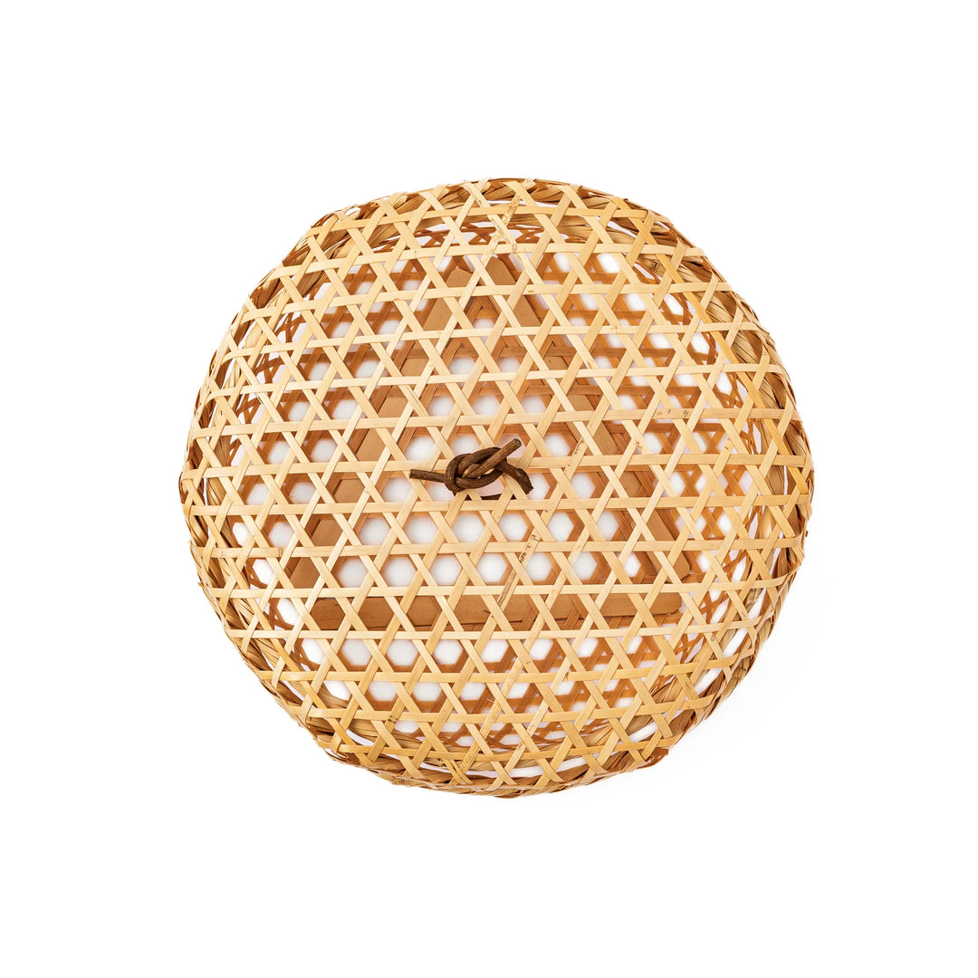 A medium round handwoven bamboo serving basket with a hexagonal mesh pattern lid resting on the woven border