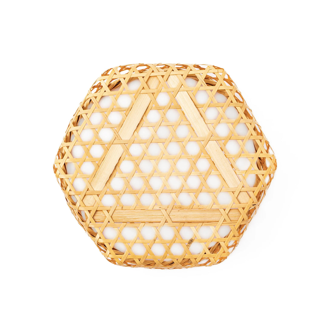 A medium round handwoven bamboo serving basket with a hexagonal mesh pattern lid resting on the woven border