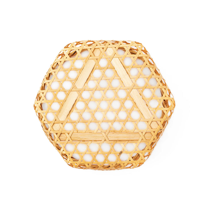 A medium round handwoven bamboo serving basket with a hexagonal mesh pattern lid resting on the woven border
