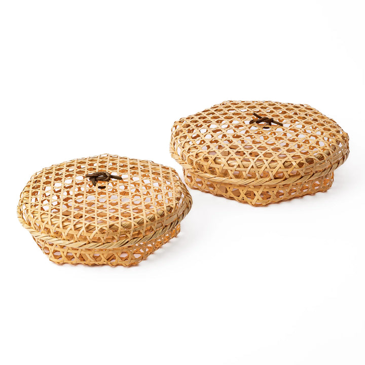 Two round handwoven bamboo serving baskets in small and medium sizes showing the matching hexagonal patterns and lids
