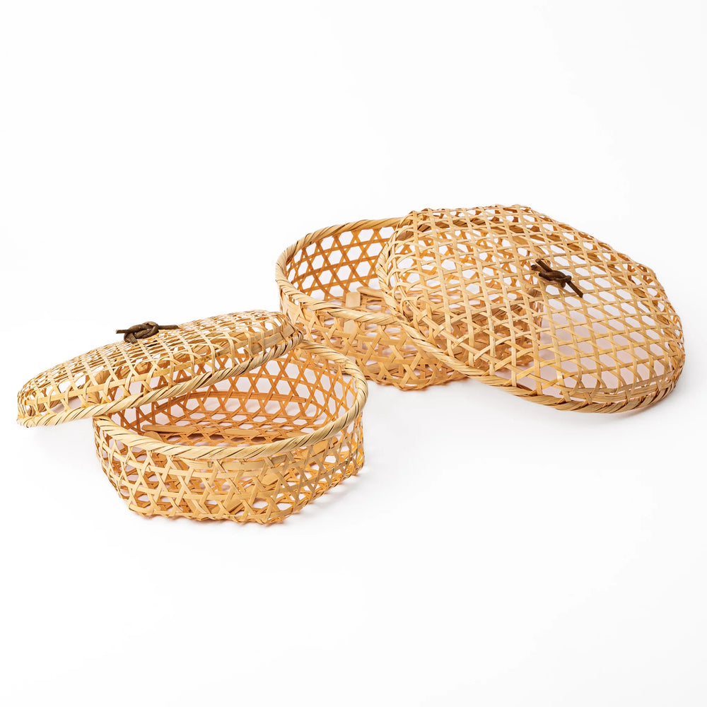 Two round handwoven bamboo serving baskets in small and medium sizes showing the matching hexagonal patterns and lids