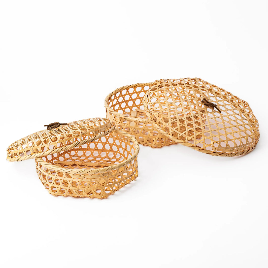 Two round handwoven bamboo serving baskets in small and medium sizes showing the matching hexagonal patterns and lids