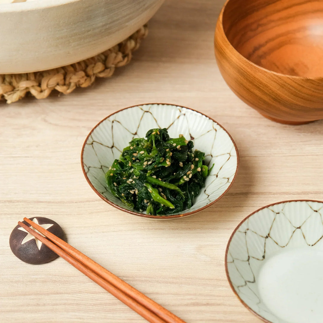 Japanese ceramic side dish bowl with geometric pattern, serving sesame spinach salad, perfect for tableware and small plates.