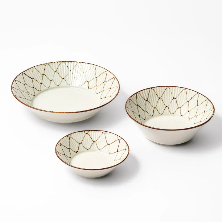 Set of three Japanese ceramic bowls with rustic diamond weave pattern and earthy rim, perfect for modern dining