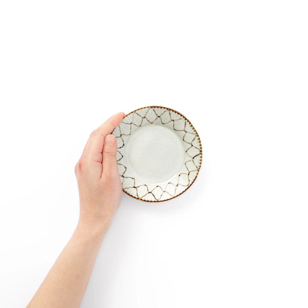 Rustic diamond weave ceramic sauce dish shown held in hand