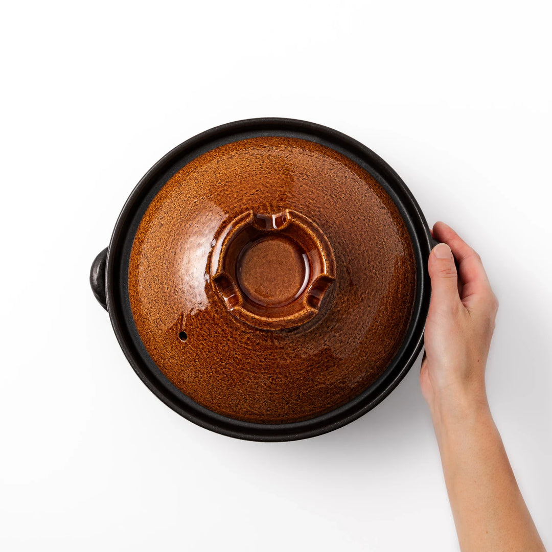 Japanese donabe clay pot with brown glazed lid and black base induction compatible for 2 to 3 person hot pot.