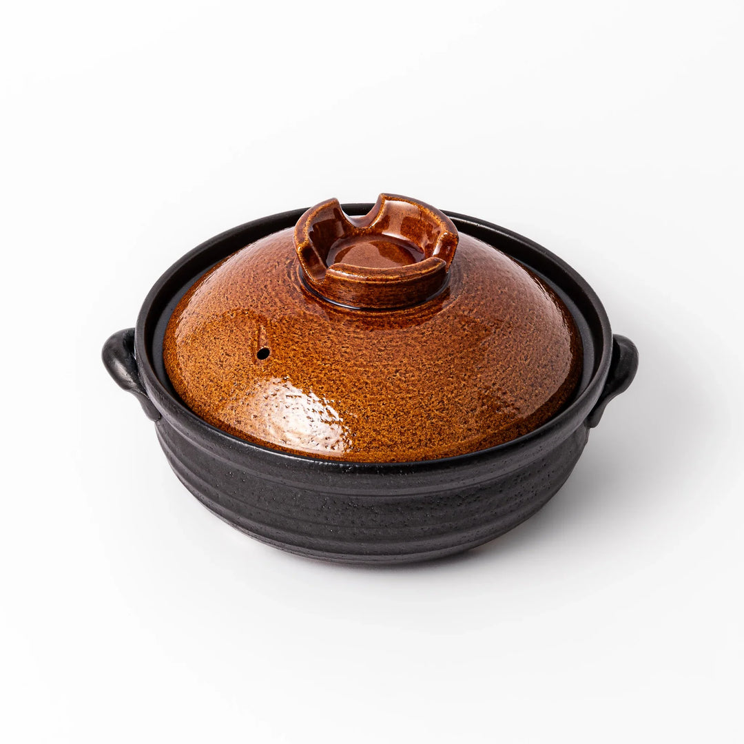 Japanese donabe clay pot with brown glazed lid and black base induction compatible for 2 to 3 person hot pot.