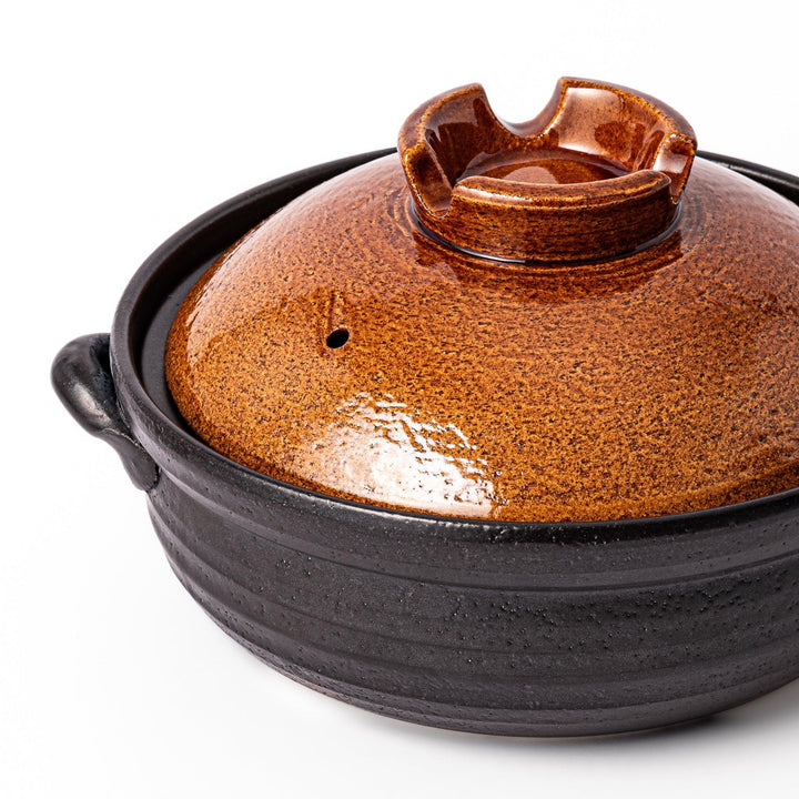Japanese donabe clay pot with brown glazed lid and black base induction compatible for 2 to 3 person hot pot.
