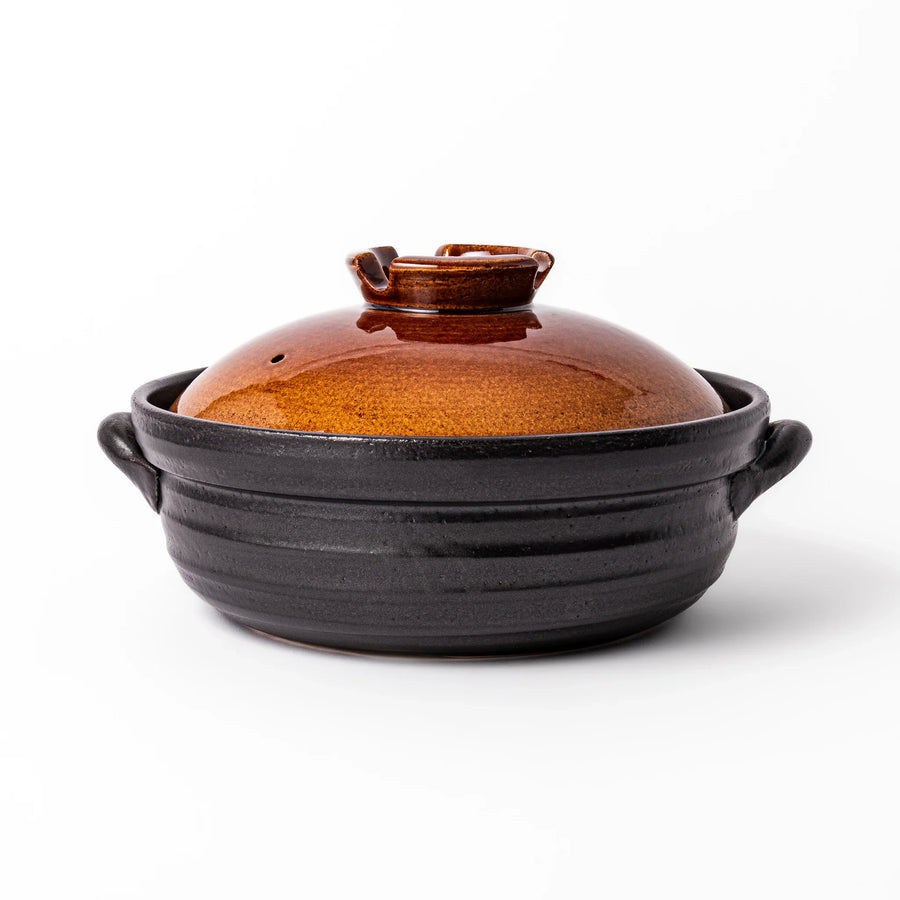 Japanese donabe clay pot with brown glazed lid and black base induction compatible for family hot pot.