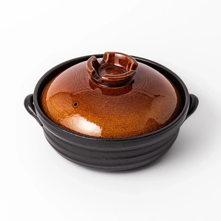 Japanese donabe clay pot with brown glazed lid and black base induction compatible for family hot pot.