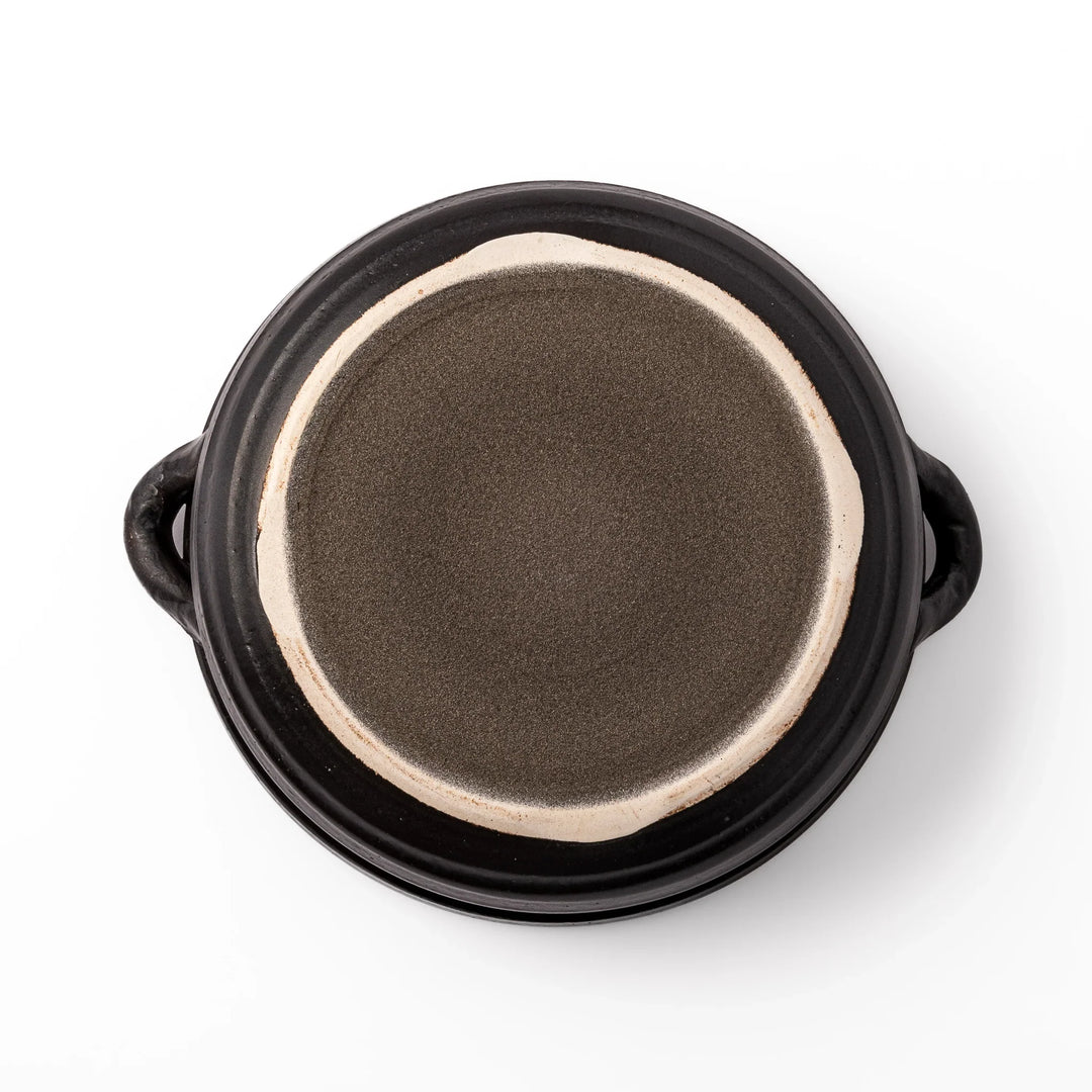 Japanese donabe clay pot with brown glazed lid and black base induction compatible for family hot pot.