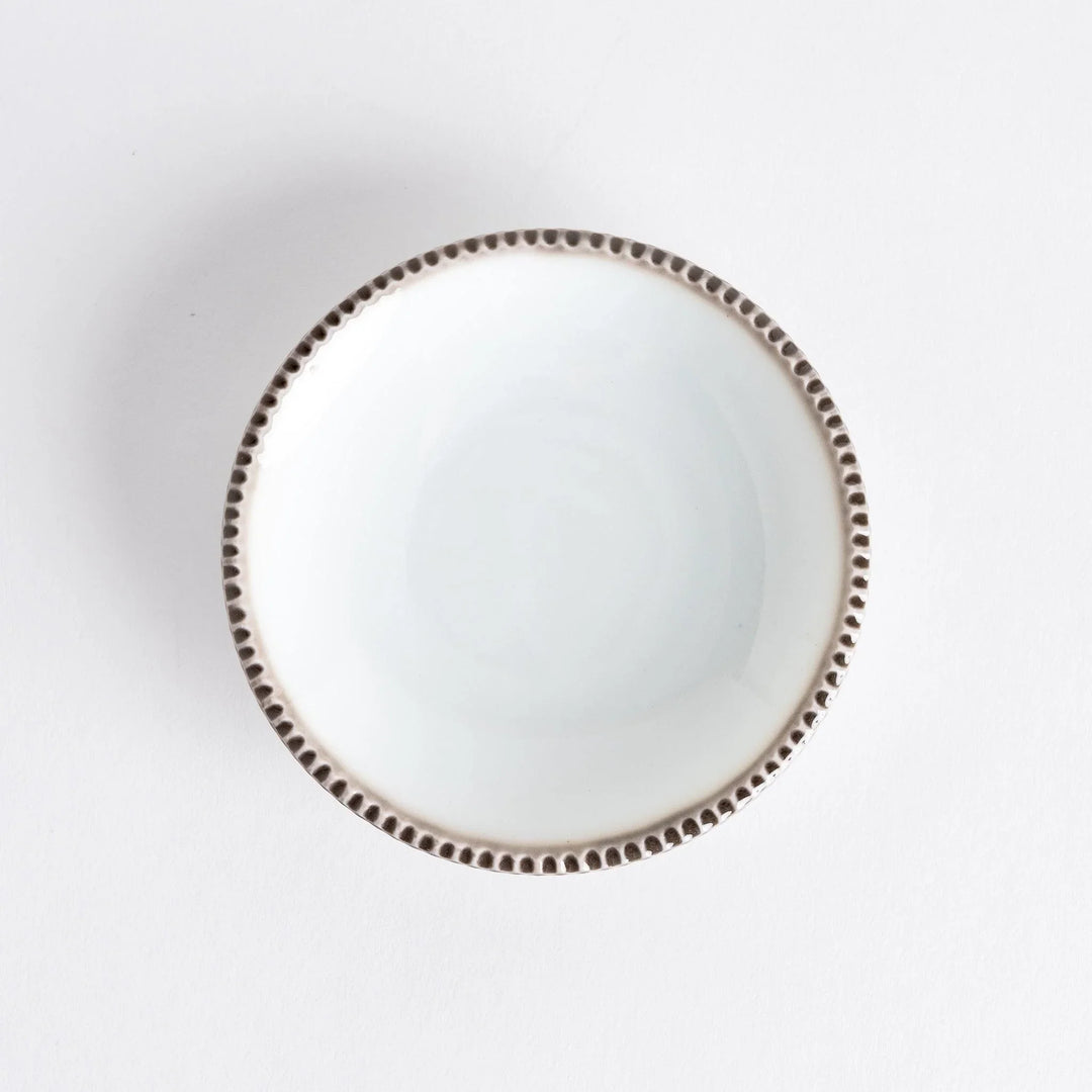 A round white sauce dish with a rustic scallop-edged border. The border comes in blue, brown, and olive.