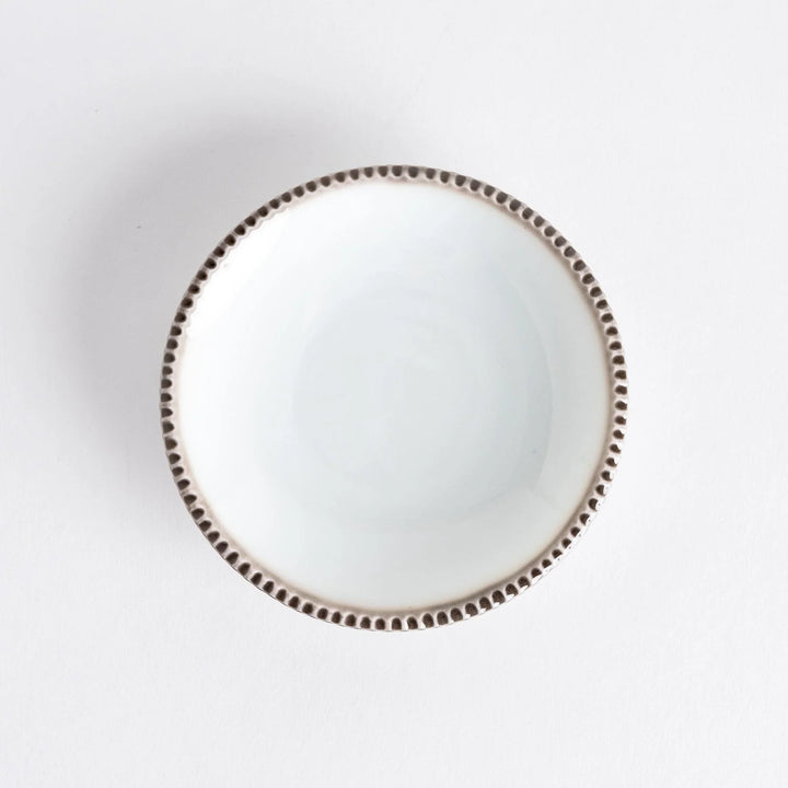 A round white sauce dish with a rustic scallop-edged border. The border comes in blue, brown, and olive.