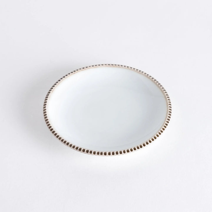A round white dessert plate with a rustic scallop-edged border. The border comes in blue, brown, and olive.
