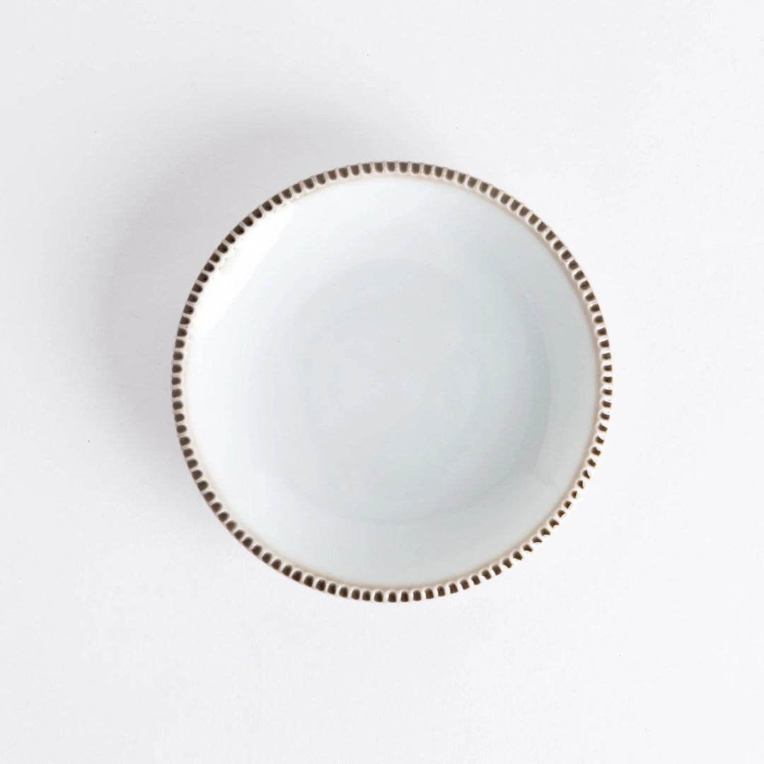 A round white dessert plate with a rustic scallop-edged border. The border comes in blue, brown, and olive.