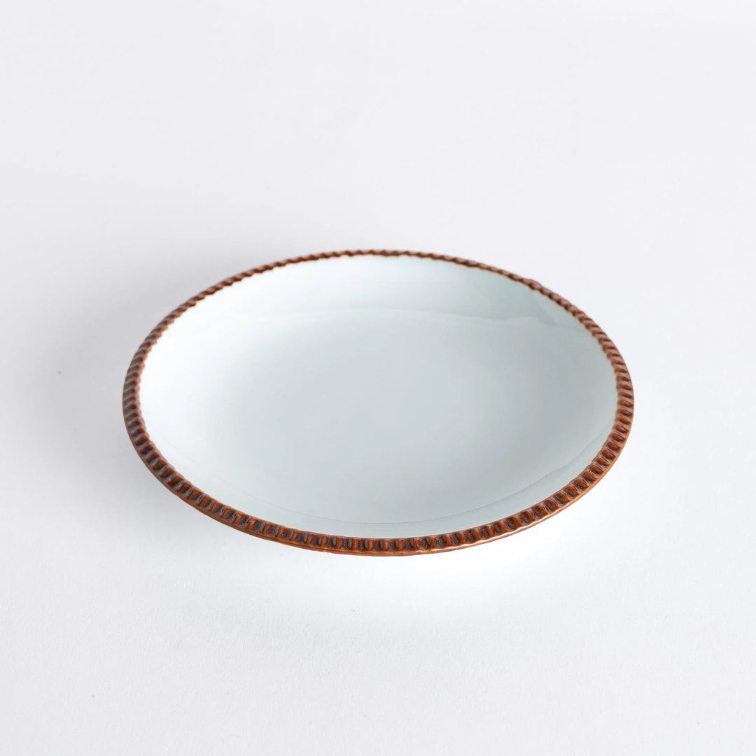 A round white dessert plate with a rustic scallop-edged border. The border comes in blue, brown, and olive.