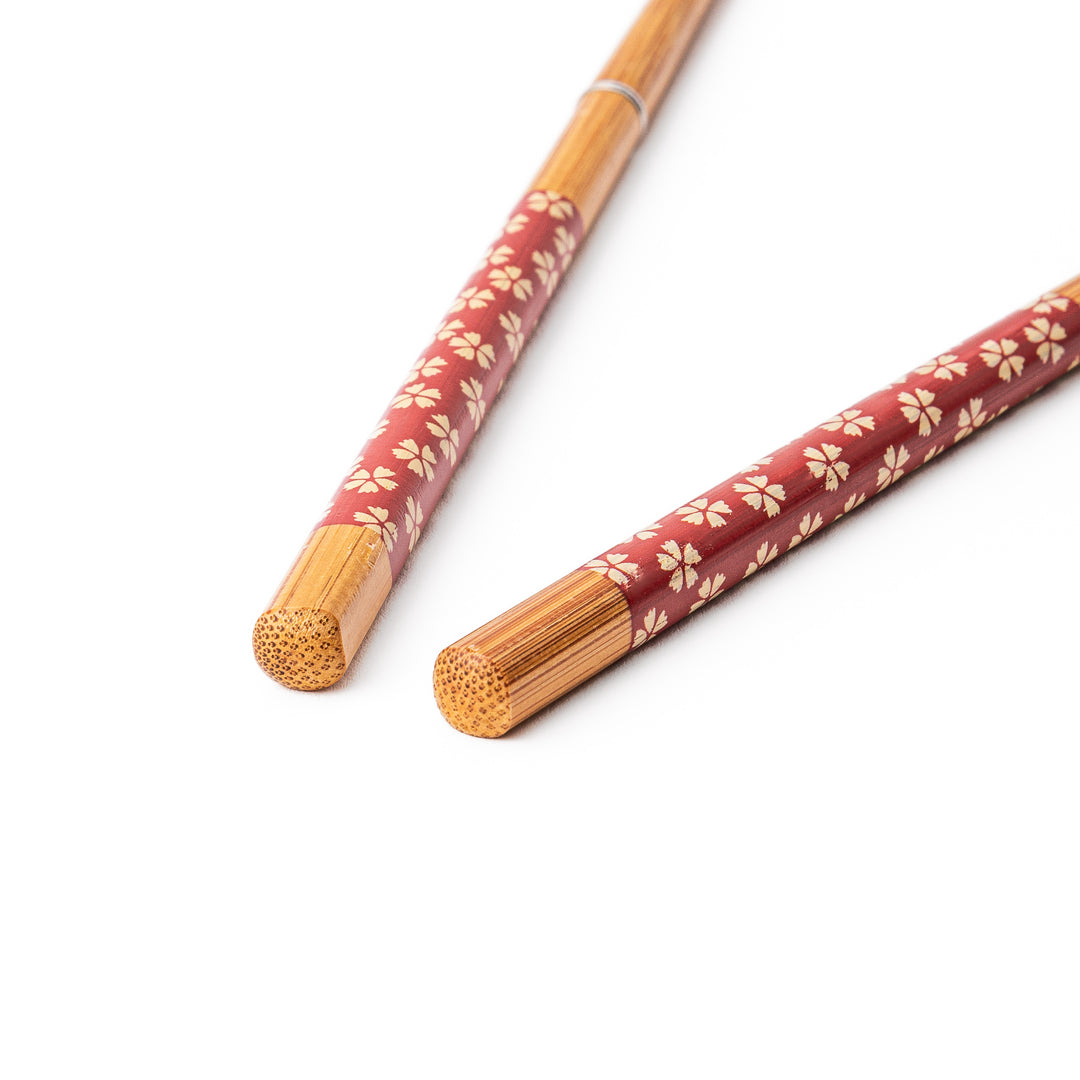 Sakura portable Japanese travel chopsticks featuring a red handle decorated with a traditional cherry blossom pattern