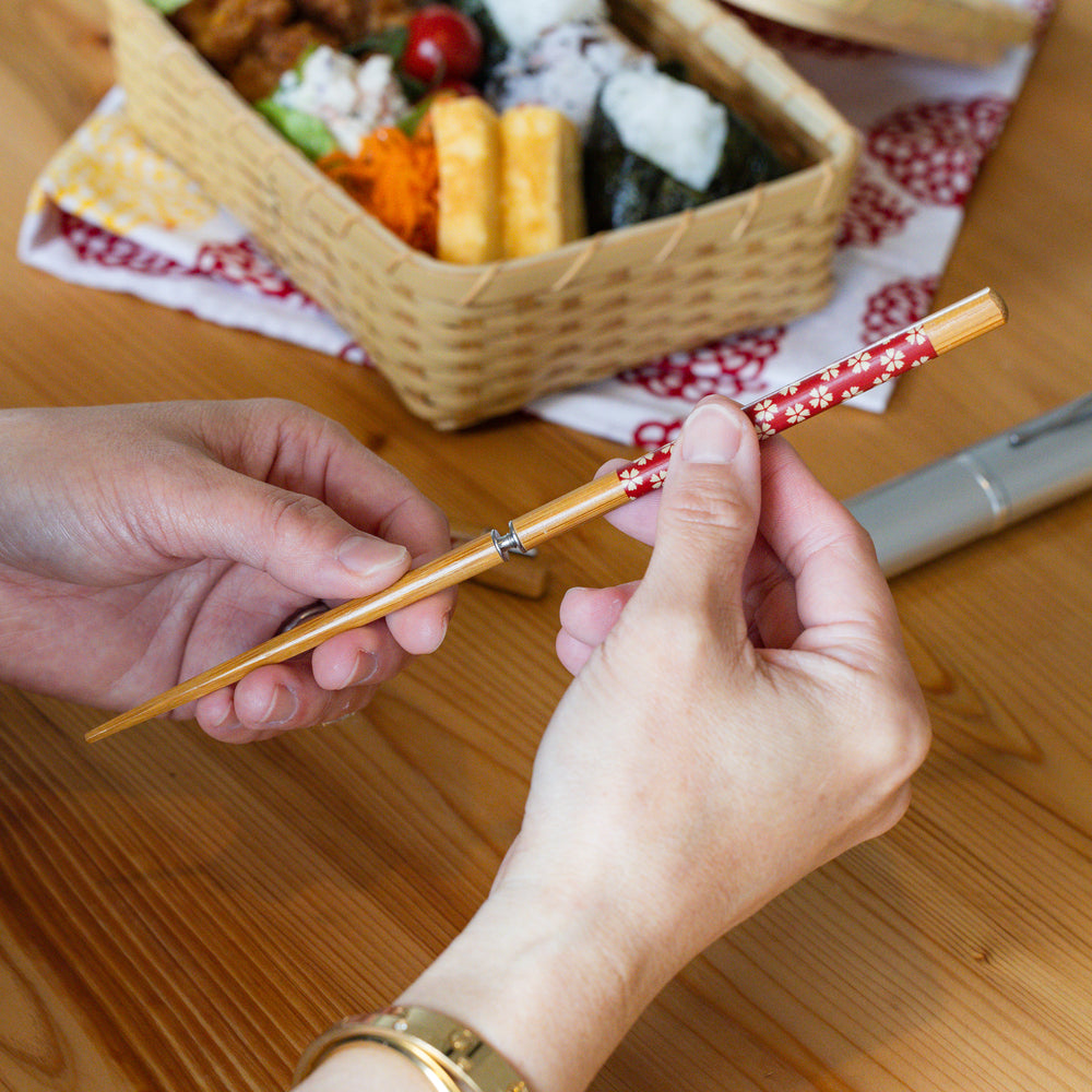 Nami from Just One Cookbook assembling sakura portable Japanese travel chopsticks with a screw on handle