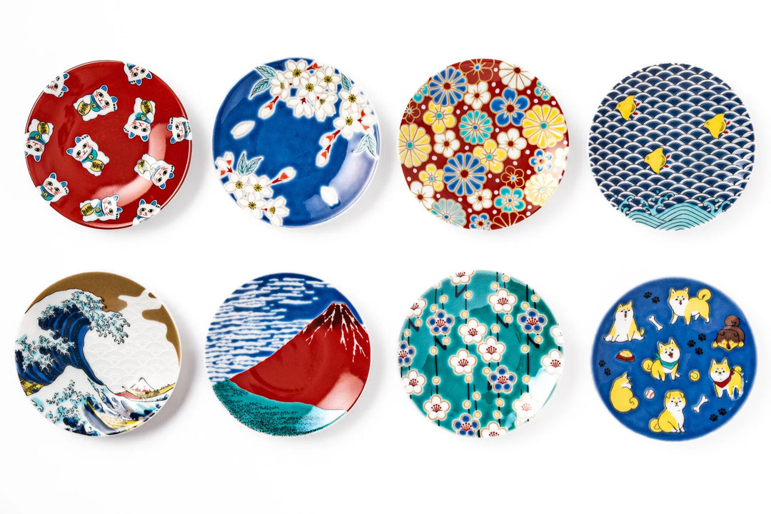 Colorful Japanese porcelain mini plates with designs including cherry blossoms waves Mount Fuji flowers lucky cats and Shiba dogs.