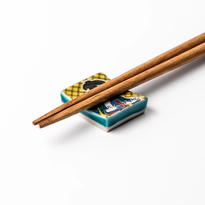 Rectangular Japanese ceramic chopstick rest with kabuki actor design inspired by Sharaku ukiyoe art.
