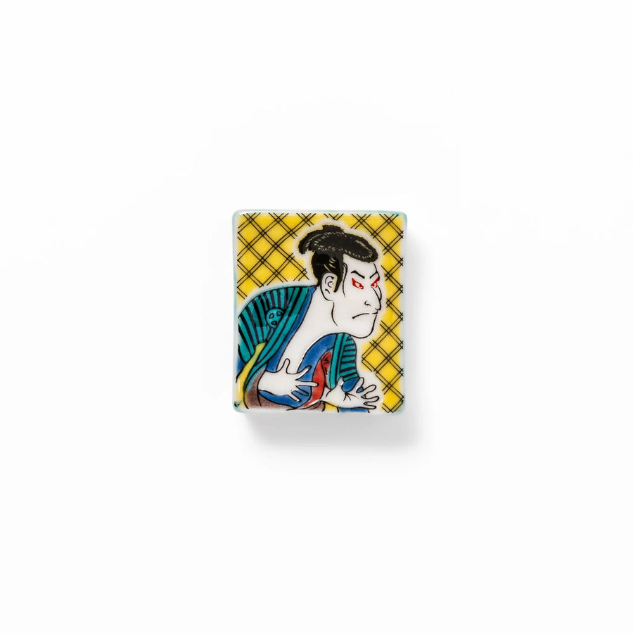 Rectangular Japanese ceramic chopstick rest with kabuki actor design inspired by Sharaku ukiyoe art.