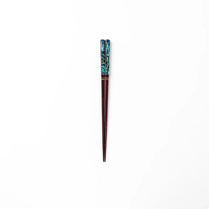 Japanese lacquer chopsticks with shimmering abalone shell inlay and deep red finish, handcrafted for elegant dining.