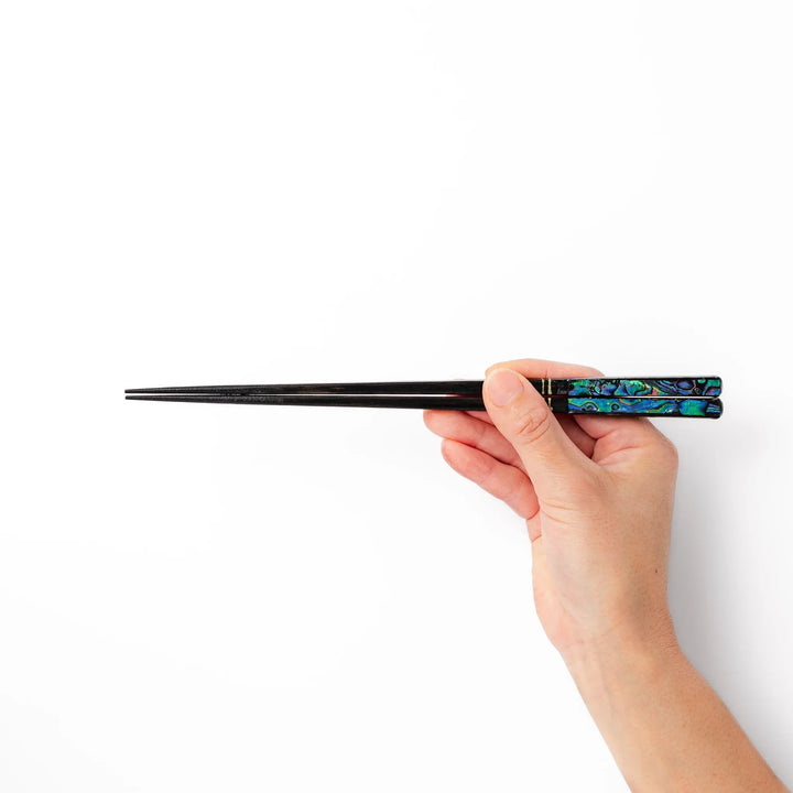 Japanese black lacquer chopsticks with shimmering abalone shell inlay, handcrafted for refined and elegant dining.
