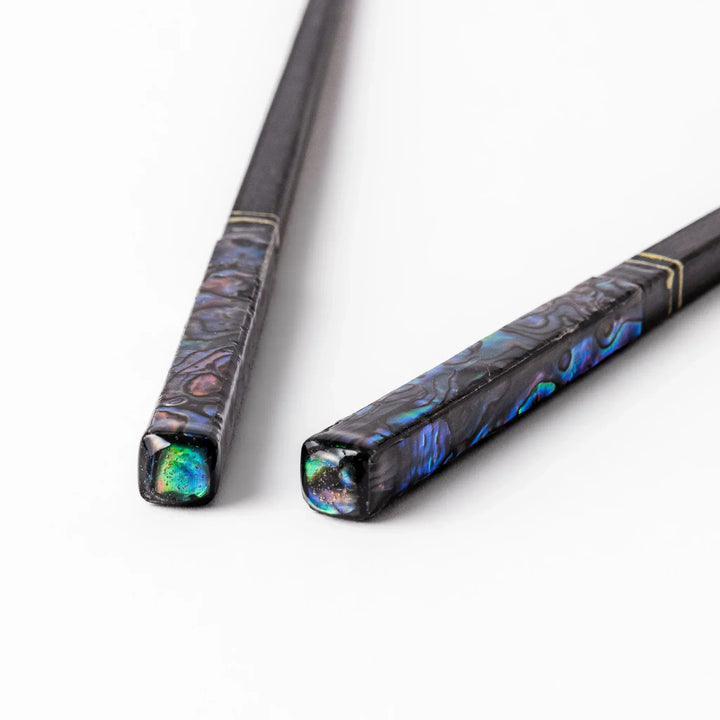Japanese black lacquer chopsticks with shimmering abalone shell inlay, handcrafted for refined and elegant dining.