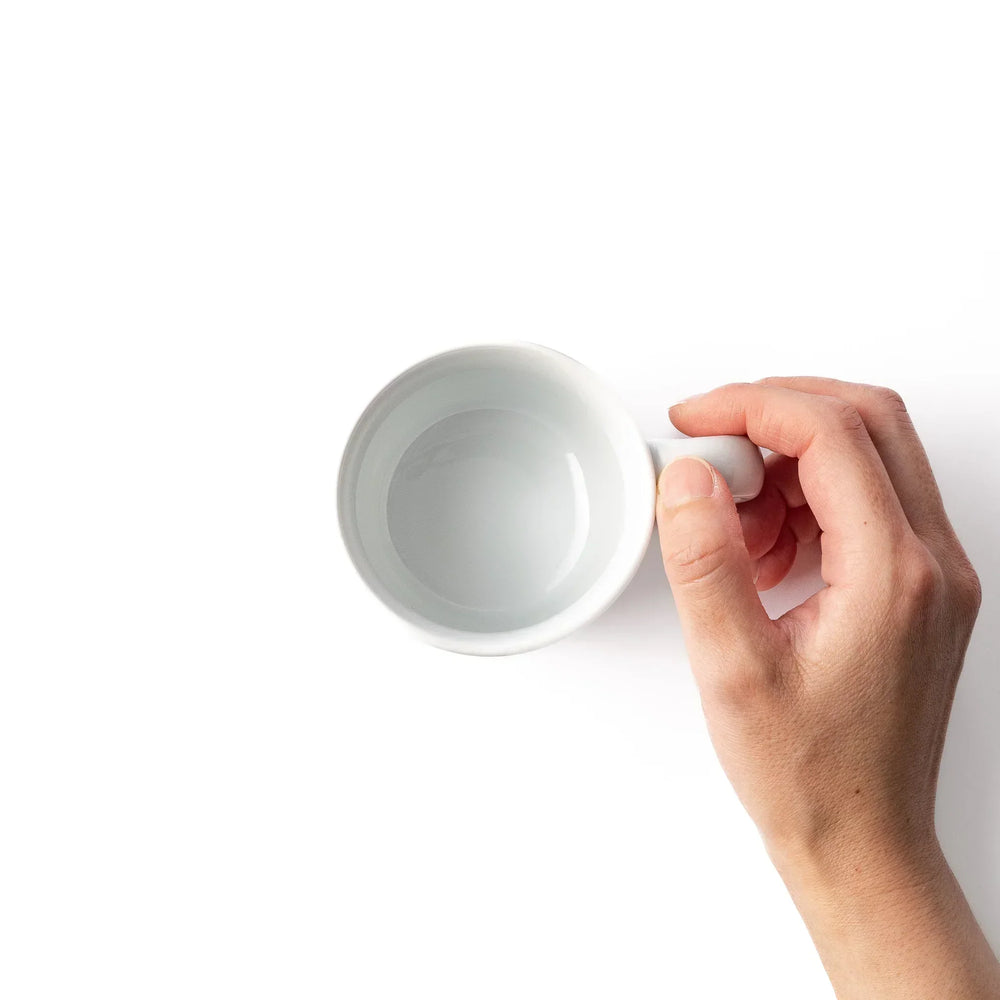 White ceramic kids mug featuring red and white Shinkansen bullet train illustration, round handle, shown on white background
