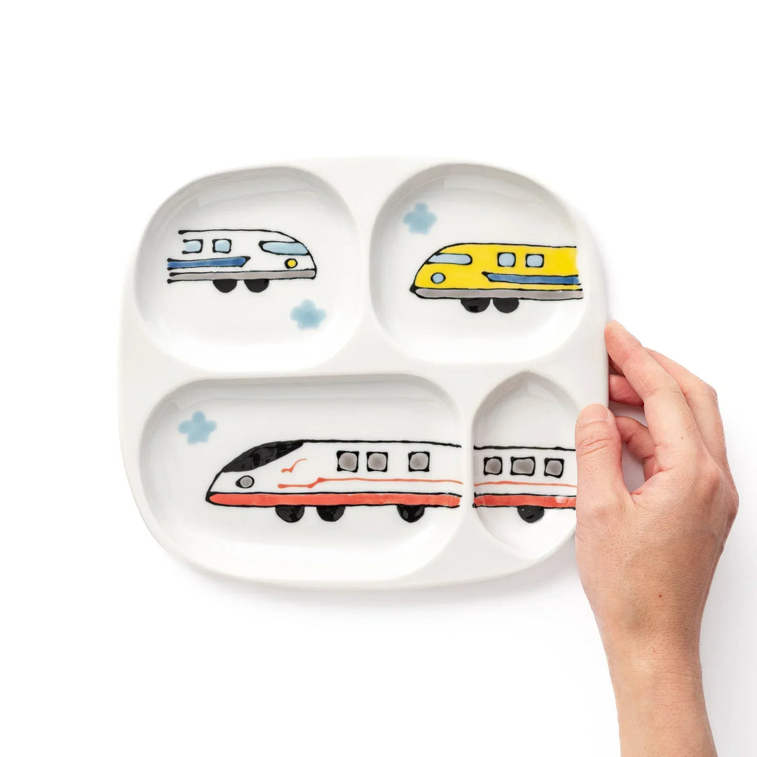 White ceramic kids plate with red, white and yellow Shinkansen train motifs in sections, accented by blue cloud details